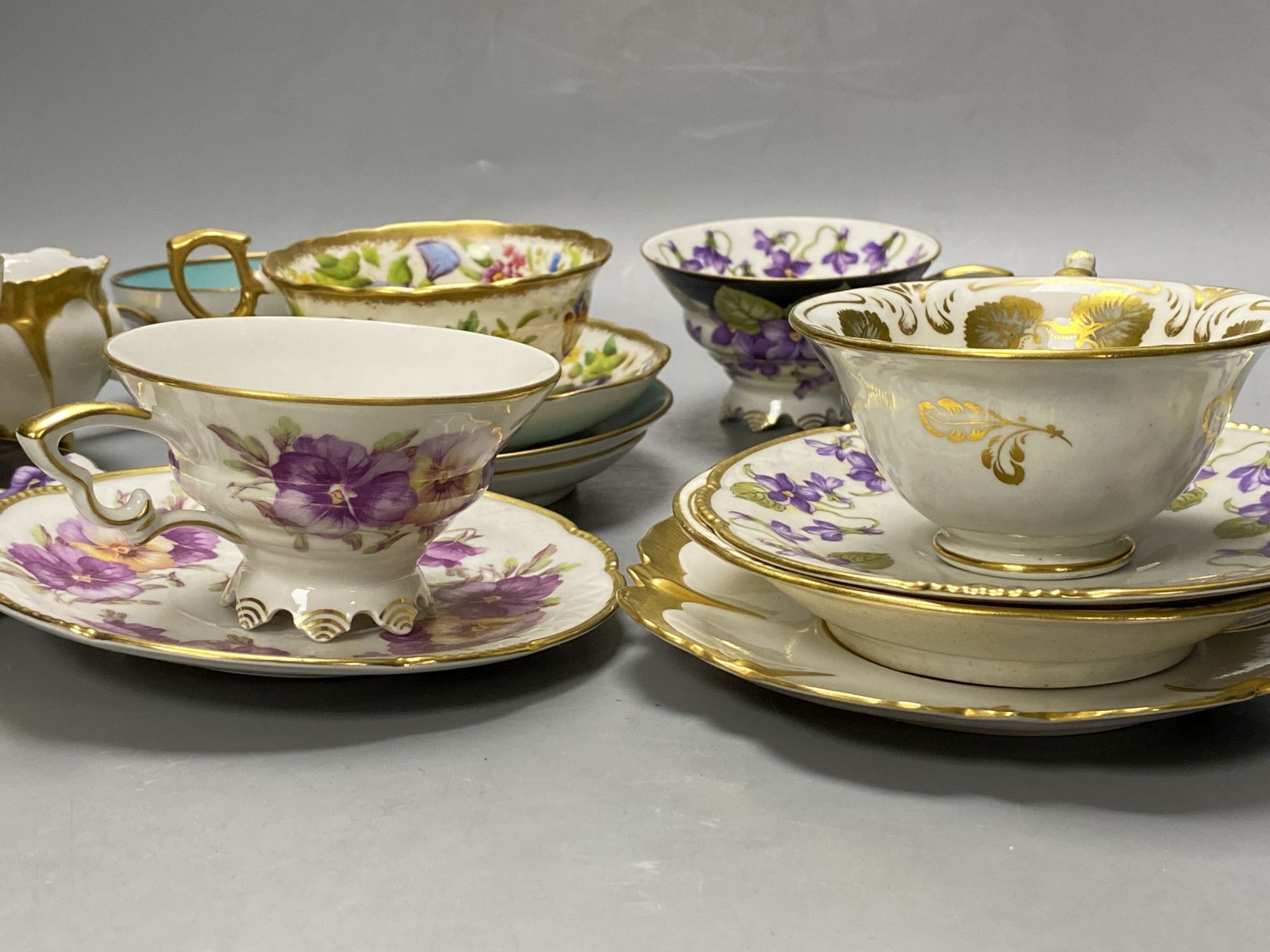 A collection of Continental porcelain tea cups and saucers